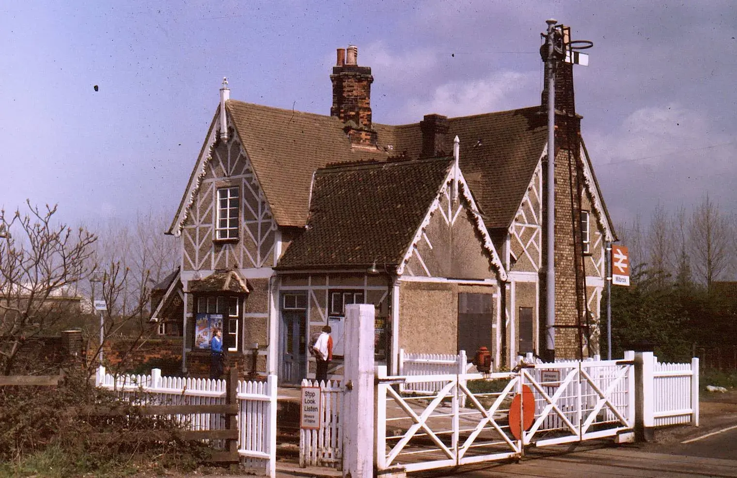 The Victorian station house with white level-crossing gates at Millbrook station