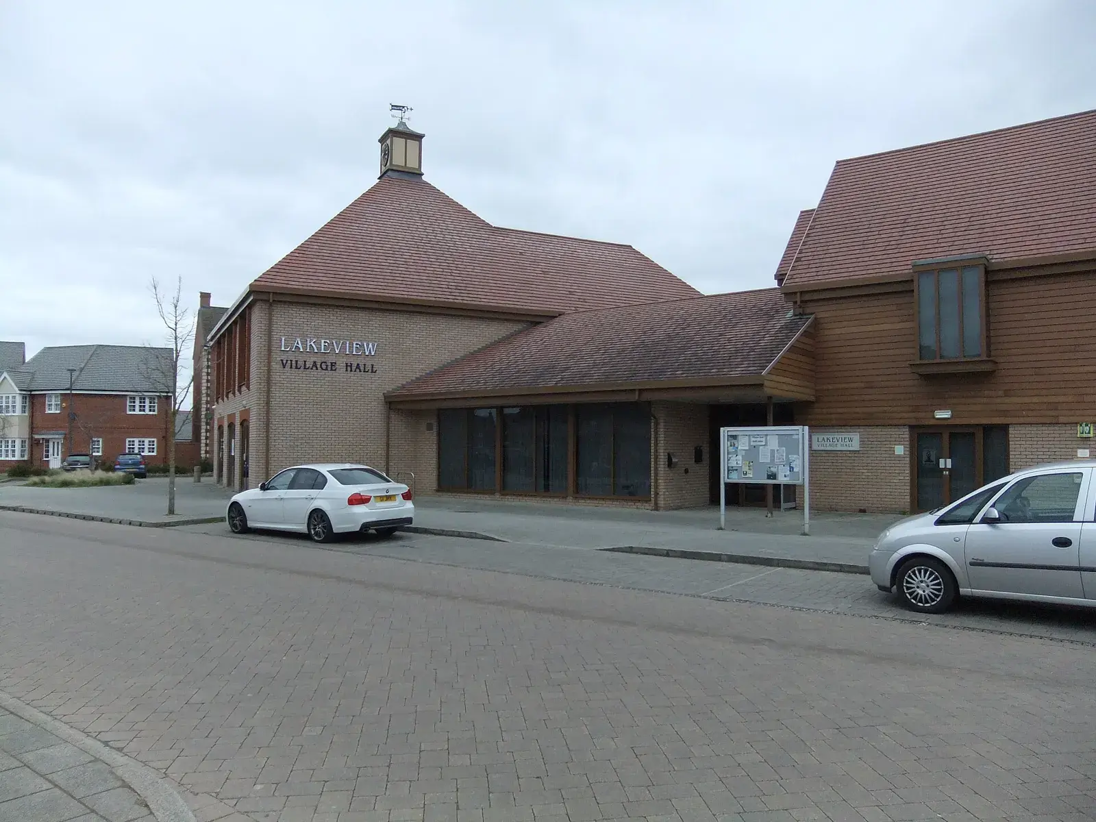 Lakeview Village Hall, a brick building with a clock turret, in Wixams